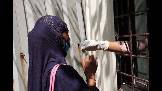 A woman is being tested for Covid at Rukminibai Hospital in Kalyan on Saturday. Kalyan and Dombivli have reported less than 50 positive cases daily on each of the last two days. (RISHIKESH CHOUDHARY/HT PHOTO)