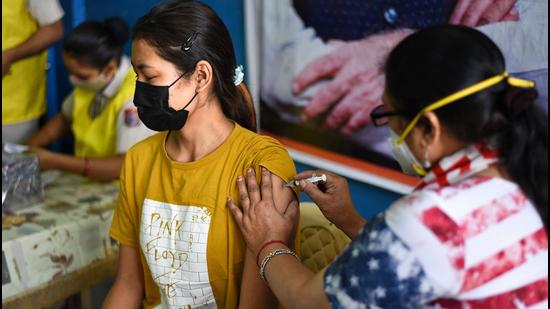 New Delhi, India - October 21, 2021: A health worker administers the Covid-19 Vaccination to the Beneficiaries as India crosses the mark of 100 crore Vaccination Doses at a Vaccination centre in Majnu Ka Tilla in New Delhi, India on Thursday, October 21, 2021. (Photo by Sanchit Khanna/ Hindustan Times) New Delhi, India - October 21, 2021: A health worker administers the Covid-19 Vaccination to the Beneficiaries as India crosses the mark of 100 crore Vaccination Doses at a Vaccination centre in Majnu Ka Tilla in New Delhi, India on Thursday, October 21, 2021. (Photo by Sanchit Khanna/ Hindustan Times)