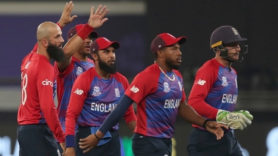 AP10 23 2021 000190B 0 1635011084965 1635011127262 Dubai: England's Moeen Ali, left, celebrates with teammates after taking the wicket of West Indies' Lendl Simmons caught by England's Liam Livingstone during the Cricket T20 World Cup match between England and the West Indies at the Dubai International Cricket Stadium, in Dubai, UAE, Saturday, Oct. 23, 2021.(AP)