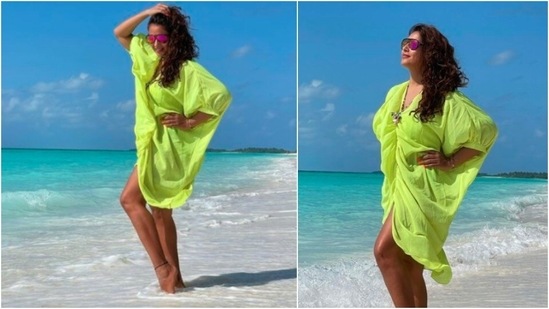 Bipasha Basu posed in this neon green beach cover-up dress as she soaked in the sun in the Maldives.(Instagram/@bipashabasu)