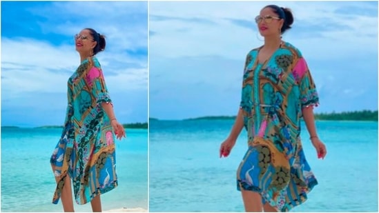 Bipasha Basu opted for this blue printed kaftan as her first look from her Maldives diaries. She teamed it with hoop earrings and reflectors.(Instagram/@bipashabasu)