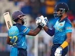 Sri Lanka's Charith Asalanka, left, celebrates with teammate Dasun Shanaka after defeating Bangladesh in their Cricket Twenty20 World Cup match in Sharjah, UAE, Sunday, Oct. 24, 2021. (AP)