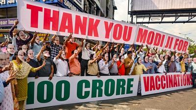 People wear face mask of Prime Minister Narendra Modi as they celebrate 1 billion vaccine dose completion in India, in Ahmedabad on Sunday. (PTI) People wear face mask of Prime Minister Narendra Modi as they celebrate 1 billion vaccine dose completion in India, in Ahmedabad on Sunday. (PTI)