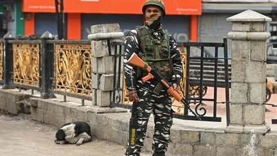 A trooper stands guard at a market in Srinagar on Sunday. (AFP)