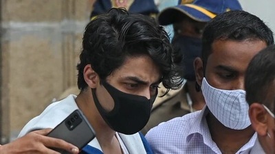 Aryan Khan, son of Shah Rukh Khan, is escorted to court by Narcotics Control Bureau (NCB) officials for a bail plea hearing. (AFP) Aryan Khan, son of Shah Rukh Khan, is escorted to court by Narcotics Control Bureau (NCB) officials for a bail plea hearing. (AFP)