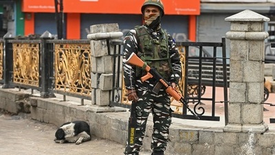 A soldier stands guard at a market in Srinagar on Sunday. (AFP) A soldier stands guard at a market in Srinagar on Sunday. (AFP)