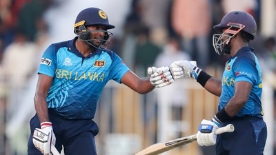 Sharjah : Sri Lanka's Bhanuka Rajapaksa, left, and Charith Asalanka gesture to each other during the Cricket Twenty20 World Cup match between Sri Lanka and Bangladesh in Sharjah, UAE, Sunday, Oct. 24, 2021 (AP) Sharjah : Sri Lanka's Bhanuka Rajapaksa, left, and Charith Asalanka gesture to each other during the Cricket Twenty20 World Cup match between Sri Lanka and Bangladesh in Sharjah, UAE, Sunday, Oct. 24, 2021 (AP)