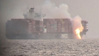 Fire cascades down from the deck of the container ship ZIM Kingston into the waters off the coast of Victoria, British Columbia, Canada. (Reuters)