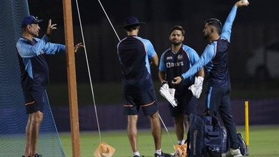 Team India cricket mentor M.S. Dhoni, right, with head coach Ravi Shastri, left, during a training session a day ahead of their match against Pakistan, in Dubai, UAE, Saturday, Oct. 23, 2021. (AP Photo/ Surjeet Kumar) (AP)