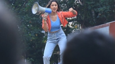 She wore a blue jeans and blue top with a red jacket for the shoot. She wore a blue jeans and blue top with a red jacket for the shoot.
