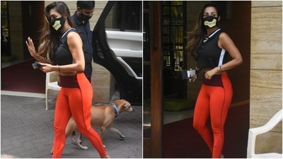Malaika chose a black sleeveless crop top for the outing and showed off a hint of her toned abs. The black cropped top came with white stripes. The 46-year-old rounded off the look with orange tights featuring a dark red waistband. (Ht Photo/Varinder Chawla) Malaika chose a black sleeveless crop top for the outing and showed off a hint of her toned abs. The black cropped top came with white stripes. The 46-year-old rounded off the look with orange tights featuring a dark red waistband. (Ht Photo/Varinder Chawla)