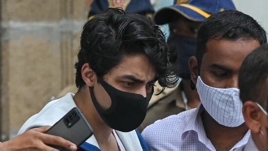 Aryan Khan, son of Shah Rukh Khan, is escorted to court by Narcotics Control Bureau (NCB) officials for a bail plea hearing. (AFP)