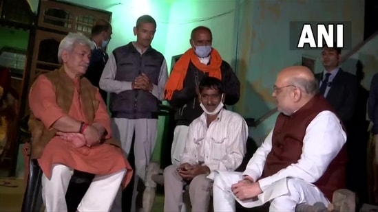 Jammu and Kashmir Lieutenant Governor Manoj Sinha (L-seated) with the local resident of Makwal along with Union home minister Amit Shah (R-seated). (ANI)
