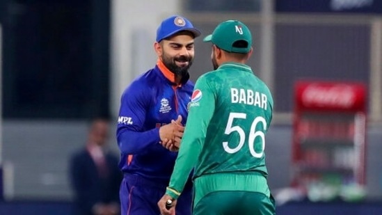 India's captain Virat Kohli, left, and Pakistan's captain Babar Azam shake hands after the toss ahead of the Cricket Twenty20 World Cup match between India and Pakistan in Dubai, UAE, Sunday, Oct. 24, 2021. (AP Photo/Aijaz Rahi)(AP)