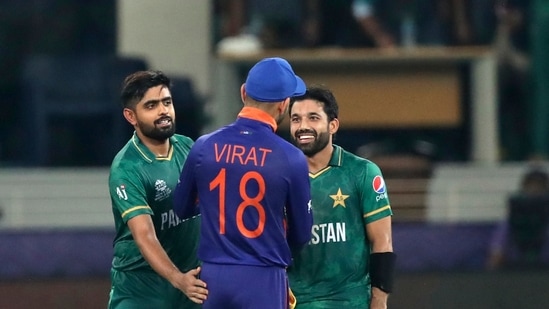 Indian cricket captain Virat Kohli congratulates Pakistan's Mohammad Rizwan, right, and Babar Azam after Pakistan won the Cricket Twenty20 World Cup match between India and Pakistan in Dubai, UAE, Sunday, Oct. 24, 2021. (AP Photo/Aijaz Rahi)(AP)