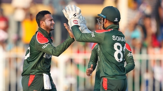 Bangladesh's Shakib Al Hasan, left, is congratulated by teammate Nurul Hasan after taking the wicket of Sri Lanka's Pathum Nissanka during the Cricket Twenty20 World Cup match between Sri Lanka and Bangladesh in Sharjah, UAE, Sunday, Oct. 24, 2021.(AP)