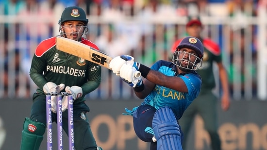 Sri Lanka's Charith Asalanka hits the ball for four runs during the Cricket Twenty20 World Cup match between Sri Lanka and Bangladesh in Sharjah, UAE, Sunday, Oct. 24, 2021.(AP)