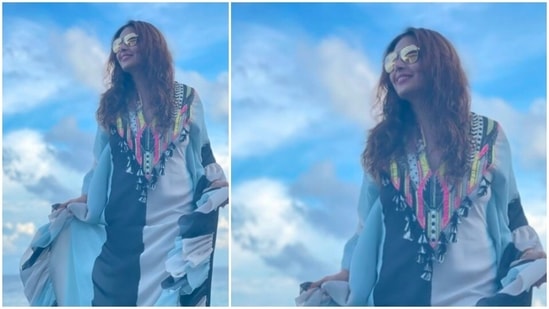 Bipasha Basu is all smiles as she poses for the camera in front of a picturesque location in the Maldives.(Instagram/@bipashabasusinghgrover)