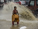 A woman drenched in rainwater reacts while crossing a road after heavy rains in New Delhi. IMD said southwest monsoon withdraws from country. (PTI) A woman drenched in rainwater reacts while crossing a road after heavy rains in New Delhi. IMD said southwest monsoon withdraws from country. (PTI)