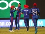 Afghanistan's Mujeeb Ur Rahman, third right, celebrates the wicket of Scotland's captain Kyle Coetzer during the Cricket Twenty20 World Cup match between Afghanistan and Scotland in Sharjah, UAE, Monday, Oct. 25, 2021. (AP) Afghanistan's Mujeeb Ur Rahman, third right, celebrates the wicket of Scotland's captain Kyle Coetzer during the Cricket Twenty20 World Cup match between Afghanistan and Scotland in Sharjah, UAE, Monday, Oct. 25, 2021. (AP)