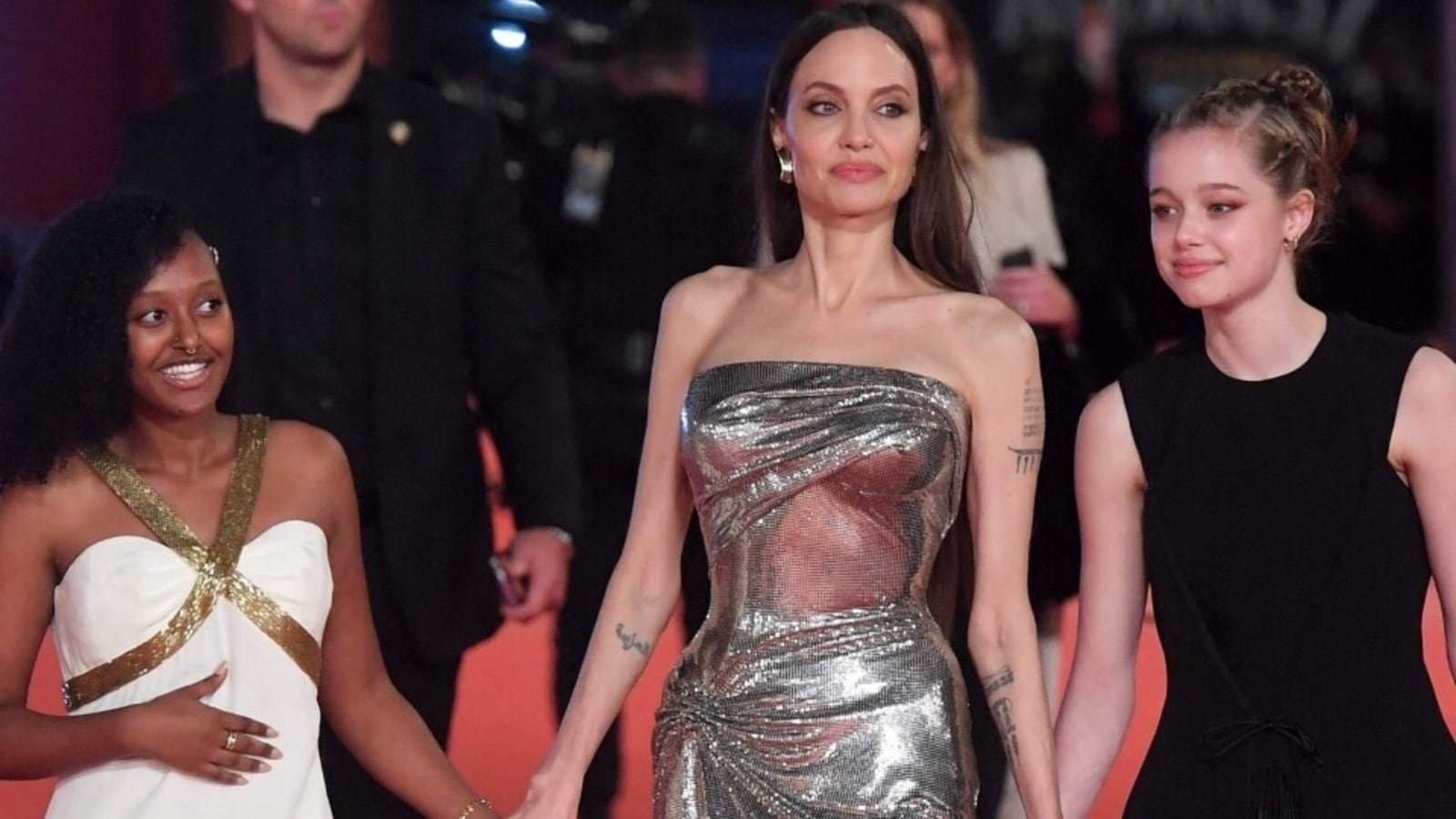 Angelina Jolie in a silver bodycon dress with Zahara JoliePitt and