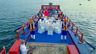 Looking straight out of a fairytale, Neha and Rohanpreet rang in their first wedding anniversary on a boat with musicians playing on one end, rowers dressed up in lieu with the theme, mountains in the backdrop, a table set for dinner, sun dipping into the waterbody in the backdrop and the couple punctuating the serene romantic landscape. (Instagram/nehakakkar)