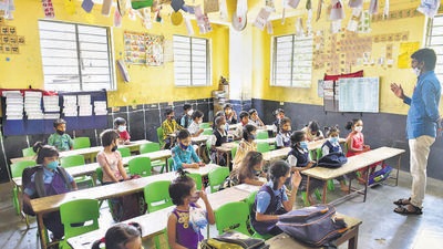 Students attend a class at a government primary school as Karnataka government allowed the schools to re-open for class Ist to Vth in Bengaluru on Monday. (PTI) Students attend a class at a government primary school as Karnataka government allowed the schools to re-open for class Ist to Vth in Bengaluru on Monday. (PTI)