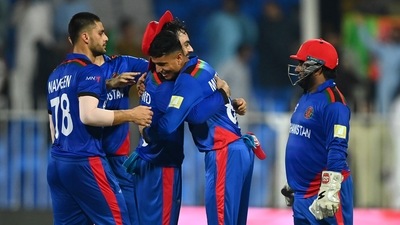 Sharjah, Oct 25 (ANI): Mujeeb Ur Rahman and Rashid Khan of Afghanistan embrace each other during the ICC Men's T20 World Cup match between Afghanistan and Scotland, at Sharjah Cricket Stadium, in Sharjah on Monday. (ANI) Sharjah, Oct 25 (ANI): Mujeeb Ur Rahman and Rashid Khan of Afghanistan embrace each other during the ICC Men's T20 World Cup match between Afghanistan and Scotland, at Sharjah Cricket Stadium, in Sharjah on Monday. (ANI)