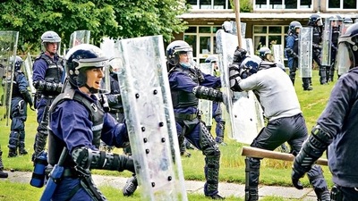 Police officers take part in a public order training session in preparation for COP26 in Glasgow on August 30. About 10,000 officers from around the UK will be deployed each day of the summit, making it one of the largest policing operations ever undertaken in Britain. AFP/FILE Police officers take part in a public order training session in preparation for COP26 in Glasgow on August 30. About 10,000 officers from around the UK will be deployed each day of the summit, making it one of the largest policing operations ever undertaken in Britain. AFP/FILE