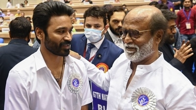 Actors Dhanush and Rajinikanth pose for a photograph during the 67th National Film Awards and Dadasaheb Phalke Awards 2019. (AFP) Actors Dhanush and Rajinikanth pose for a photograph during the 67th National Film Awards and Dadasaheb Phalke Awards 2019. (AFP)