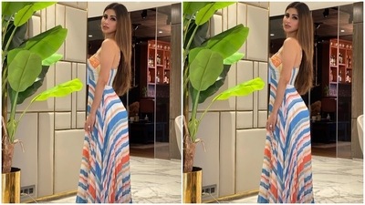 For the at-home shoot, Mouni slipped into a spaghetti-strapped maxi dress from the shelves of clothing label, Verb by designer Pallavi Singhee. The dress comes adorned with orange, blue, white, red, and green striped patterns. It also features a sweetheart neckline and a fit-and-flare silhouette. (Instagram/@imouniroy)
