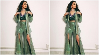 Sonakshi accessorised her attire with layered silver chains, a chunky choker necklace, several rings on both hands, and large hoop earrings. Centre parted open locks with frizzed curls, winged eyeliner, nude lip shade, and minimal make-up completed the glam. (Instagram/@mohitrai) Sonakshi accessorised her attire with layered silver chains, a chunky choker necklace, several rings on both hands, and large hoop earrings. Centre parted open locks with frizzed curls, winged eyeliner, nude lip shade, and minimal make-up completed the glam. (Instagram/@mohitrai)