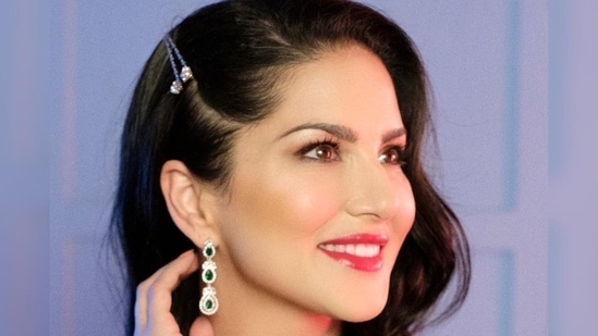 Dolled up in an emerald green satin saree, Sunny collected its well draped pleats on her shoulder and teamed it with an encrusted embroidered cut sleeves blouse that came with a plunging neckline to ooze oomph.(Instagram/sunnyleone)