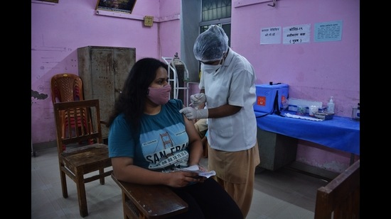 A woman gets her vaccination against Covid at Nursing College vaccination centre in Thane on Monday. (PRAFUL GANGURDE/HT PHOTO)