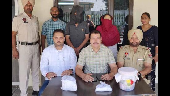 The drug accused and his female aide in Ludhiana police custody on Monday. (HT Photo)