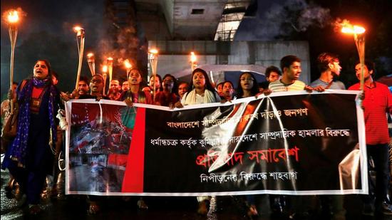 Bangladeshi activists join in a torch procession demanding justice for the violence against Hindus during Durga Puja festival, Dhaka, Bangladesh, October 18, 2021. (REUTERS)