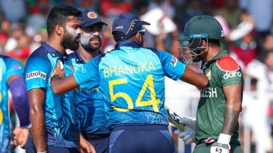 Bangladesh's Liton Das, right, gestures to Sri Lankan bowler Lahiru Kumara, left, as Sri Lanka's Bhanuka Rajapaksa keeps them apart during the Cricket Twenty20 World Cup match between Sri Lanka and Bangladesh in Sharjah, UAE, Sunday, Oct. 24, 2021.&nbsp;(AP)