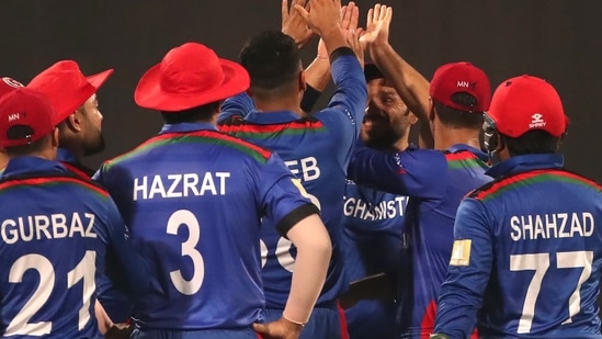 Afghanistan players celebrate the wicket of Scotland's captain Kyle Coetzer during the Cricket Twenty20 World Cup match between Afghanistan and Scotland in Sharjah, UAE, Monday, Oct. 25, 2021.(AP)