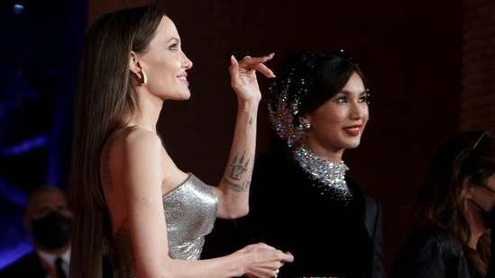 Angelina Jolie and Gemma Chan smile for the cameras as they pose on the red carpet of Rome Film Fest. Gemma Chan looked ethereal in an embellished two-piece attire from the label Miss Sohee.(AP)