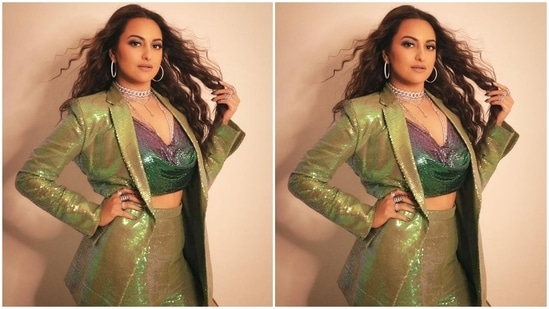 Sonakshi wore a champagne green sequinned long blazer with notch-lapel collars and double pockets on both sides. She wore it over a cowl neck embellished top that flaunted her midriff. A pair of champagne green sequinned flared pants with front slits rounded off Sonakshi's attire.(Instagram/@mohitrai)