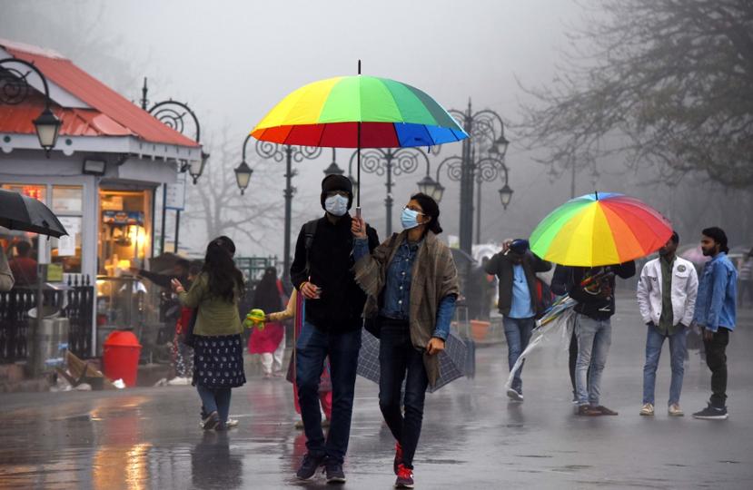 Residents enjoying the rain at the Ridge in Shimla on Sunday evening. (Deepak Sansta/HT)