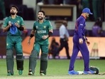 Pakistan skipper Babar Azam and Mohammad Rizwan walk after being congratulated by India's captain Virat Kohli on their victory in the ICC men's Twenty20 World Cup cricket match against India, at the Dubai International Cricket Stadium, in Dubai on Sunday.(ANI ) Pakistan skipper Babar Azam and Mohammad Rizwan walk after being congratulated by India's captain Virat Kohli on their victory in the ICC men's Twenty20 World Cup cricket match against India, at the Dubai International Cricket Stadium, in Dubai on Sunday.(ANI )