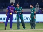 India's Bhuvneshwar Kumar congratulates Pakistan's cricket captain Babar Azam, centre and Mohammad Rizwan after Pakistan won the Cricket Twenty20 World Cup match between India and Pakistan in Dubai,(AP) India's Bhuvneshwar Kumar congratulates Pakistan's cricket captain Babar Azam, centre and Mohammad Rizwan after Pakistan won the Cricket Twenty20 World Cup match between India and Pakistan in Dubai,(AP)