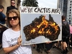 A woman holds up a sign as she takes part in a protest to call for action on climate change in Melbourne, Australia.&nbsp;