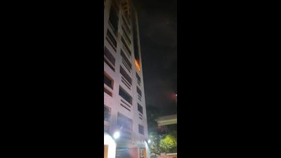 Fire breaks out on the fifth floor of the Ascona Building of Raheja Gardens, Thane, on Tuesday morning. (HT PHOTO)