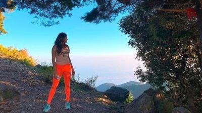 Janvi Kapoor gets clicked while standing under a tree, admiring the beauty of Uttarakhand. (Instagram/@janhvikapoor)