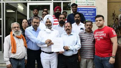 BJP leaders outside the MC’s Zone D office in Ludhiana on Tuesday. (Harsimar Pal Singh/HT)