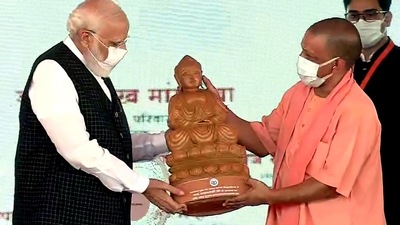 Uttar Pradesh Chief Minister Yogi Adityanath felicitates Prime Minister Narendra Modi with an idol of Gautama Buddha during the inauguration of the nine Medical Colleges, in Siddharthnagar. (ANI)
