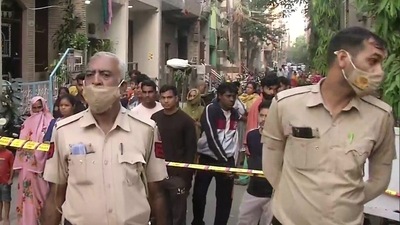 Delhi: Police personnel present at the spot in Old Seemapuri after four person were found dead in the fire. (Photo via ANI) Delhi: Police personnel present at the spot in Old Seemapuri after four person were found dead in the fire. (Photo via ANI)