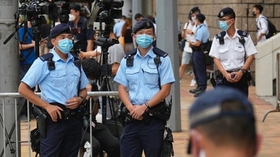 Police officers standing guard outside a court in Hong Kong in July, after the first sentencing under the National Security Law.&nbsp; (Associated Press)